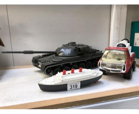 A Tonka fire engine, clockwork boat and a battery operated tank