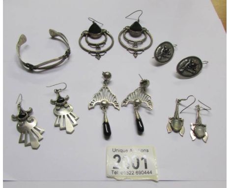 5 pairs of silver earrings and a silver bangle.