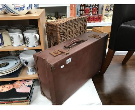 A vintage suitcase and a wicker basket