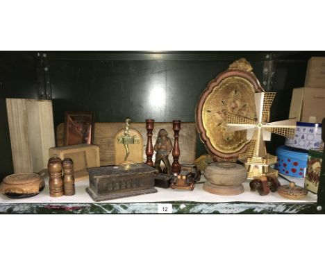 A large shelf of wooden items including candlesticks, figures, windmill etc.