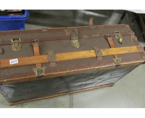 A vintage steamer trunk with interior tray.