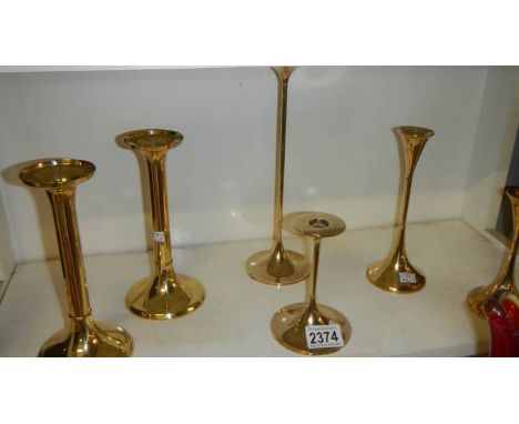 A collection of 6 Danish brass modernist candlesticks consisting of 2 graduated candlesticks by Torben Orksov, 2 graduated ca
