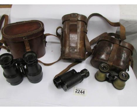 A pair of vintage opera glasses in a Negretti &amp; Zambra case, a pair of French binoculars 'Lumiere Extra' in case and a Pr