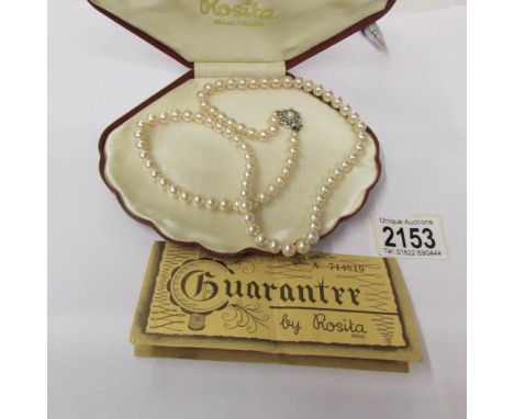 A pearl necklace by Rosita with guarantee dated 3/10/90, in case.
