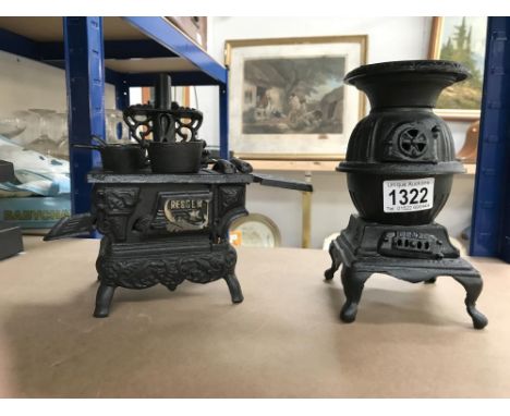 2 miniature cast iron display cooking range and a pot belly stove