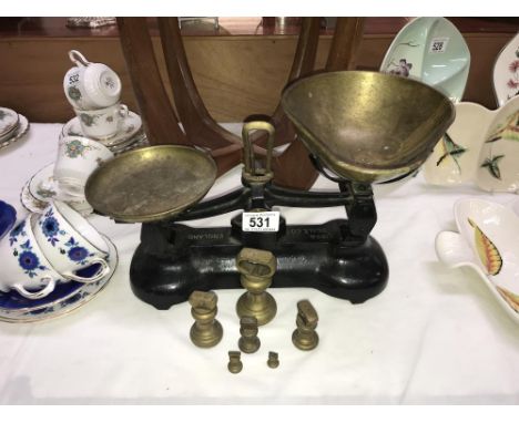 A cast iron Libra Scale company kitchen scales with brass pans and weights