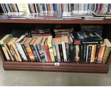 A shelf of paperbac books including Sci-Fi