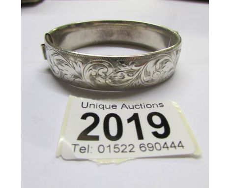 A silver bangle, approximately 35 grams.