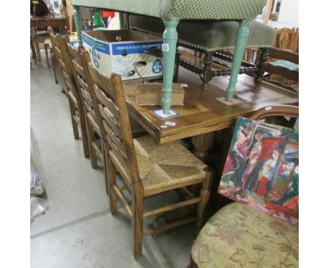 A good oak draw leaf dining table with 6 ladder back chairs.