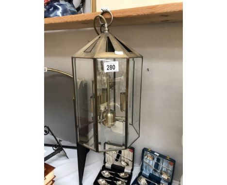 An antiqued brass finished hall lantern with 8 bevelled glass panels