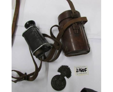 A cased monocular by J. A. Odonohoe, 34, Strand, London and a British Army Royal Scots Fusiliers brass furcap badge.