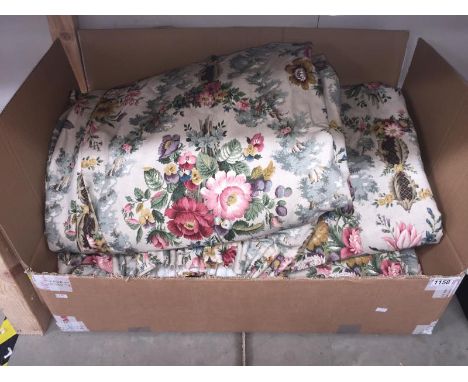 A pair of curtains with swags and tails by Sanderson