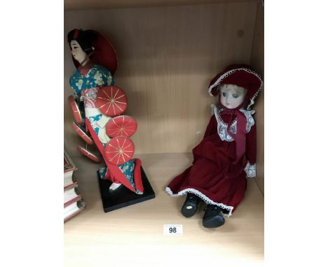 A vintage oriental doll and 1 other