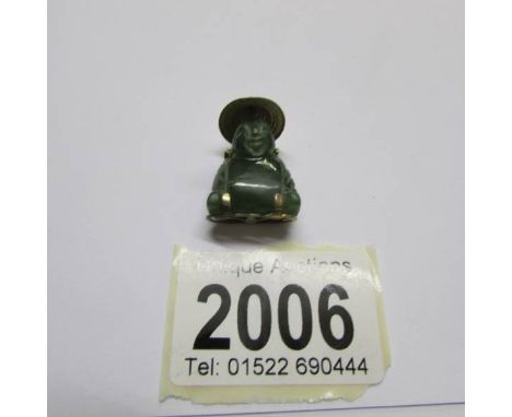 A Jade and yellow metal Buddha pendant.
