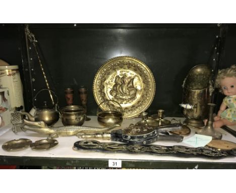 A shelf of brassware