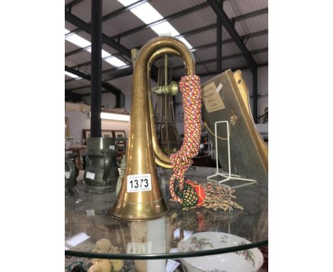 A copper bugle with Royal Welsh fusiliers emblem