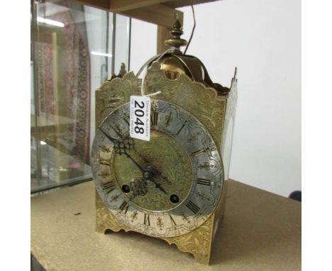 A brass lantern clock.
