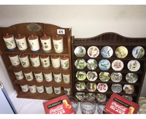 A Centenary collection of small plates on a rack and Sarahs Garden spice jars on rack