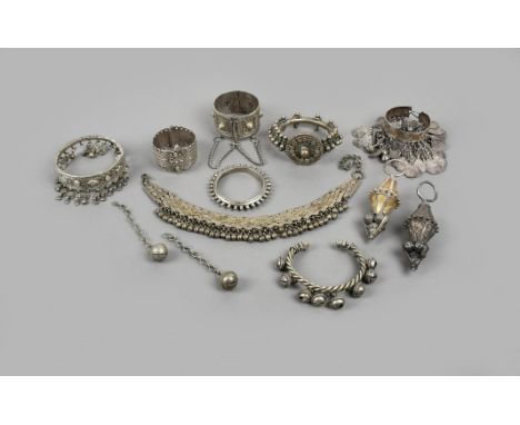 Six Yemen bracelets silver coloured metal, one hung with bells, one hung with heart shape pendants and bells, a Berber bracel