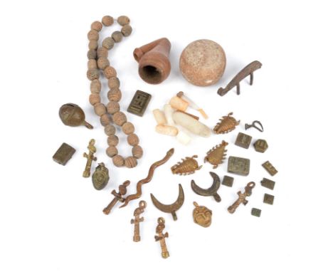 Ten Ashanti geometric gold weights Ghana brass, the longest 3.7cm, various pendants and ornaments, a pottery pipe bowl, a str