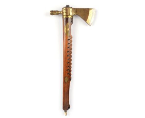 A Plains pipe tomahawk steel with brass mounts and pipe bowl with stamped and incised decoration, the wooden shaft with carve