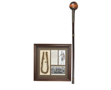 A Zulu knobkerrie South Africa with copper and steel wire bands, 71.5cm long, and a Zulu brass button necklace, mounted, fram