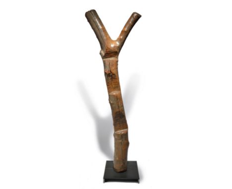 A Dogon ladder Mali 144cm high, on a metal base. (2) Provenance Michael and Marlene Pennie Collection.