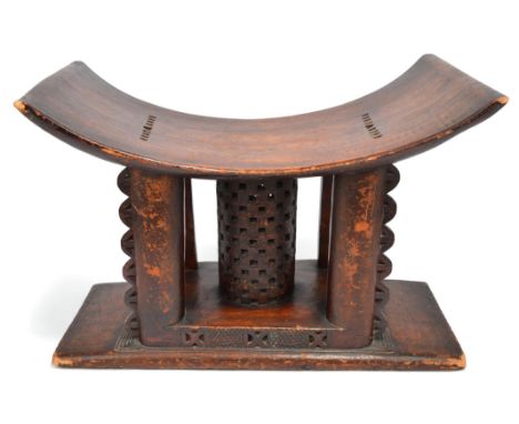 An Ashanti stool Ghana with a pierced central column support, 42cm high, 60.5cm long.
