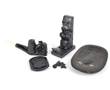 Five argillite carvings Northwest Coast including an oblong dish carved a whale with inlaid mother of pearl eyes, 17cm long, 