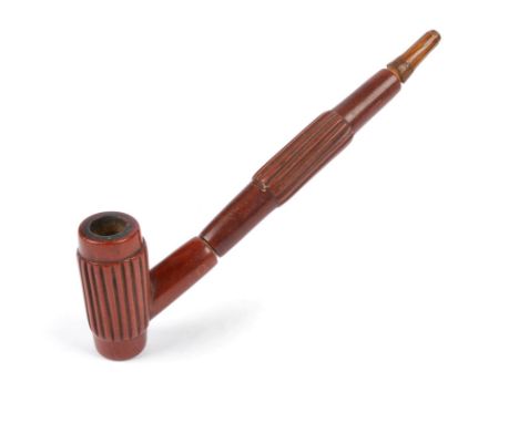 A Plains pipe possibly Sioux catlinite and wood, in three parts with a ribbed bowl and stem, with a tapering mouthpiece, 23cm