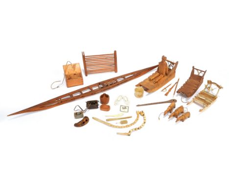 λThree Inuit model sleighs Greenland pine, cedar and bone, the wooden examples with bone runners, the larger with an articula