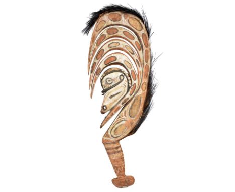 A Sepik hunting charm figure Papua New Guinea with an ancestor head with applied cowrie shells, scroll beaks, with pigment de
