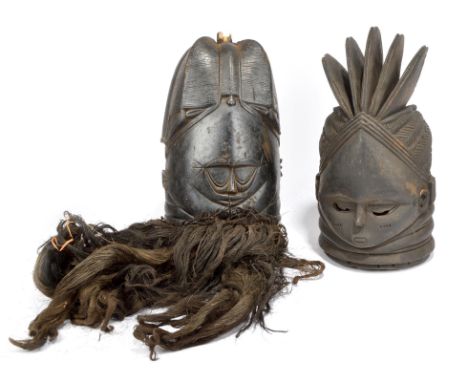 A Mende helmet mask Sierra Leone with a fine quadripartite coiffure and pierced crescent eyes, with fibre and hair mounts, 35