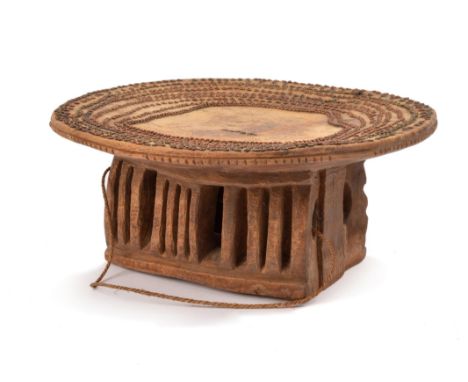 A Kikuyu stool Kenya the top inset copper and brass chain links, with a word in the centre, on a rectangular carved and pierc