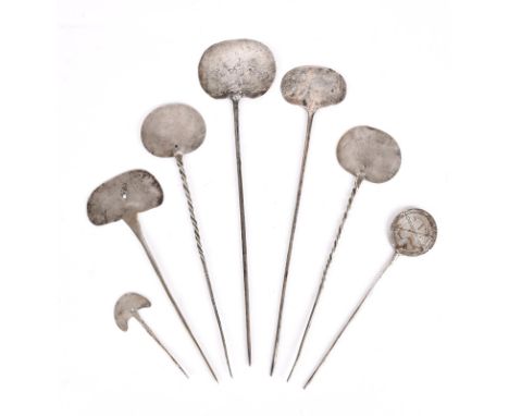 Seven cloak pins tupu Central and South America, circa 700 - 1500 AD and later silver coloured metal, with disc, oval and cre