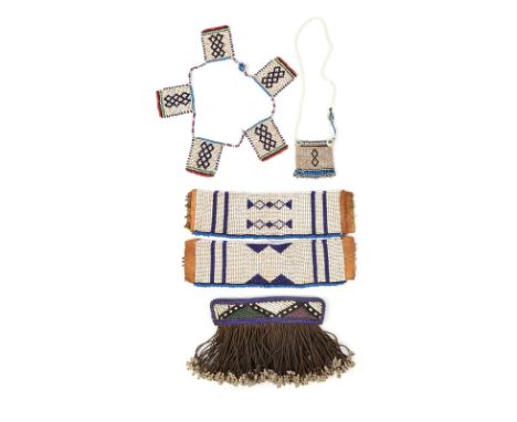 A Ndebele cache-sexe South Africa glass beads, cloth and fibre tassels, 12.5cm long, a pair of Zulu blue and white bead ankle