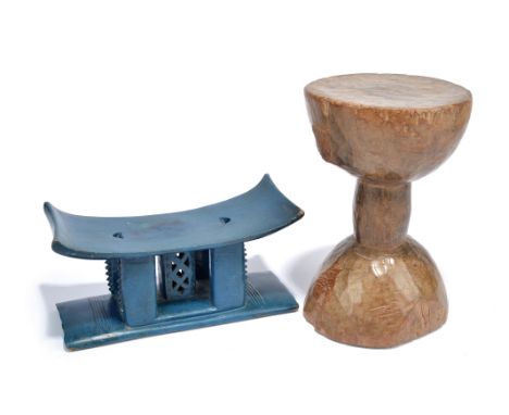 An Ashanti child's stool Ghana painted blue, 13.5cm high, and a Tanzania hour-glass shape stool, handle missing, 27cm high. (