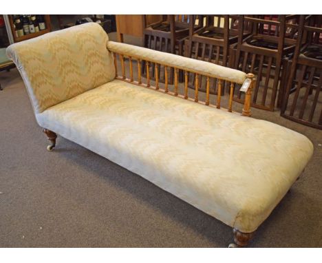 Victorian walnut framed chaise longue, having spindle turned gallery back, scroll arm and raised on bulbous turned supports f