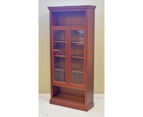 Mahogany bookcase fitted pair of glazed doors with open shelf above and below   Condition: 