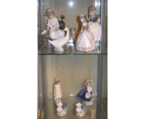 Lladro figure of a girl holding parasol and one other of a girl with basket of flowers, together with a collection of Nao fig