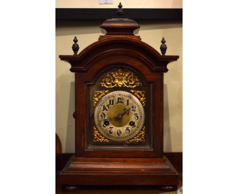 Late 19th Century walnut cased mantel clock having arched brass dial with silvered chapter ring   Condition: 