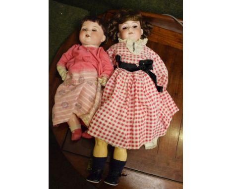 Two Armand Marseille bisque head dolls, the larger having a jointed composition body, the other with a fixed composition body