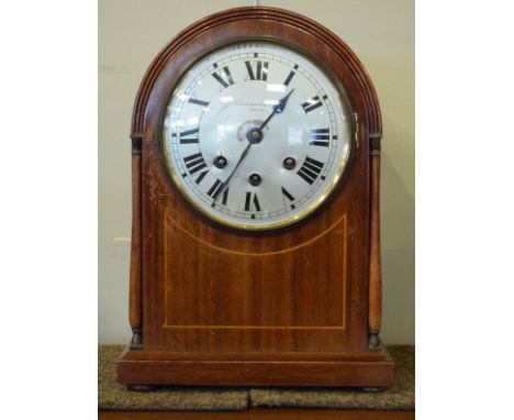 Early 20th Century string inlaid mahogany arched top mantel clock, the silvered dial with Arabic numerals   Condition: 