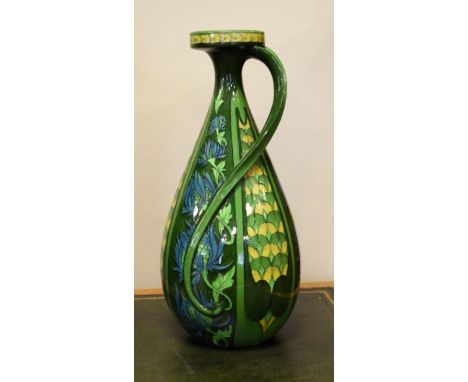 Foley Intarsio slender jug having Art Nouveau flower head and scale ground decoration in green, blue and yellow, base with bl