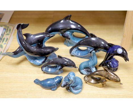 Six Poole pottery dolphins together with two similar seals and an otter