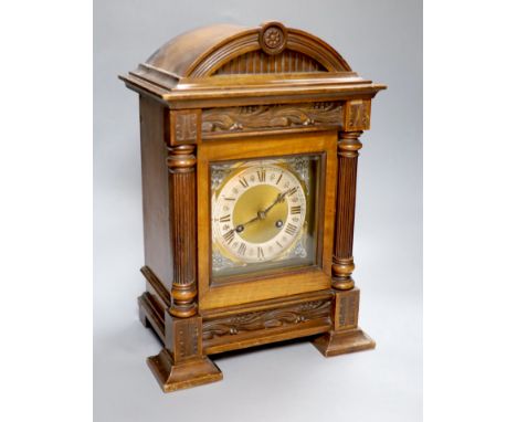 A German walnut mantel clock, converted to electric regulation, height 44cm