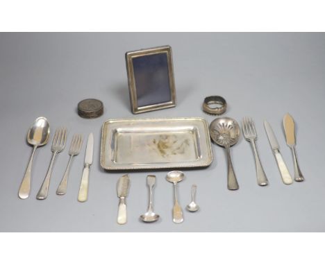 An 800 white metal stand, 16.4cm, twelve items of assorted silver flatware, a silver napkin ring, a modern silver mounted pho