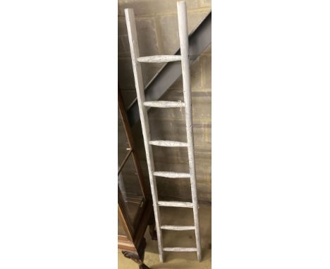 A vintage white painted wood seven tread ladder, width 30cm, height 170cm