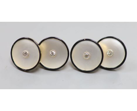 A pair of yellow metal (stamped 18), mother of pearl , black enamel and diamond set cufflinks, 12mm, gross 7.7 grams.CONDITIO