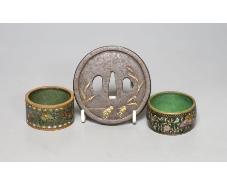 A 19th century Japanese iron and parcel gilt tsuba, unsigned, 8cm and two cloisonne enamel napkin rings.